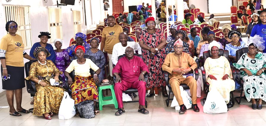 Elderly attendees and volunteers at a Mercy Hands outreach event